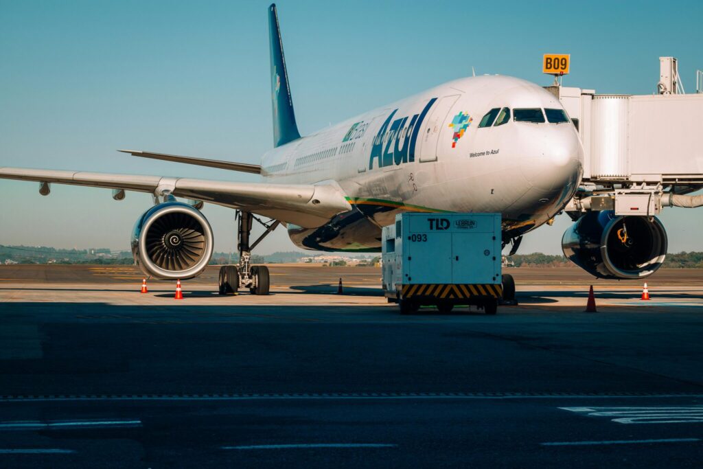 A large airplane parked on the runway, showcasing its impressive size and design against a clear sky backdrop.