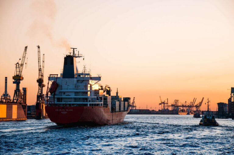 A large ship gracefully sails through calm waters, showcasing its impressive size against the serene backdrop.